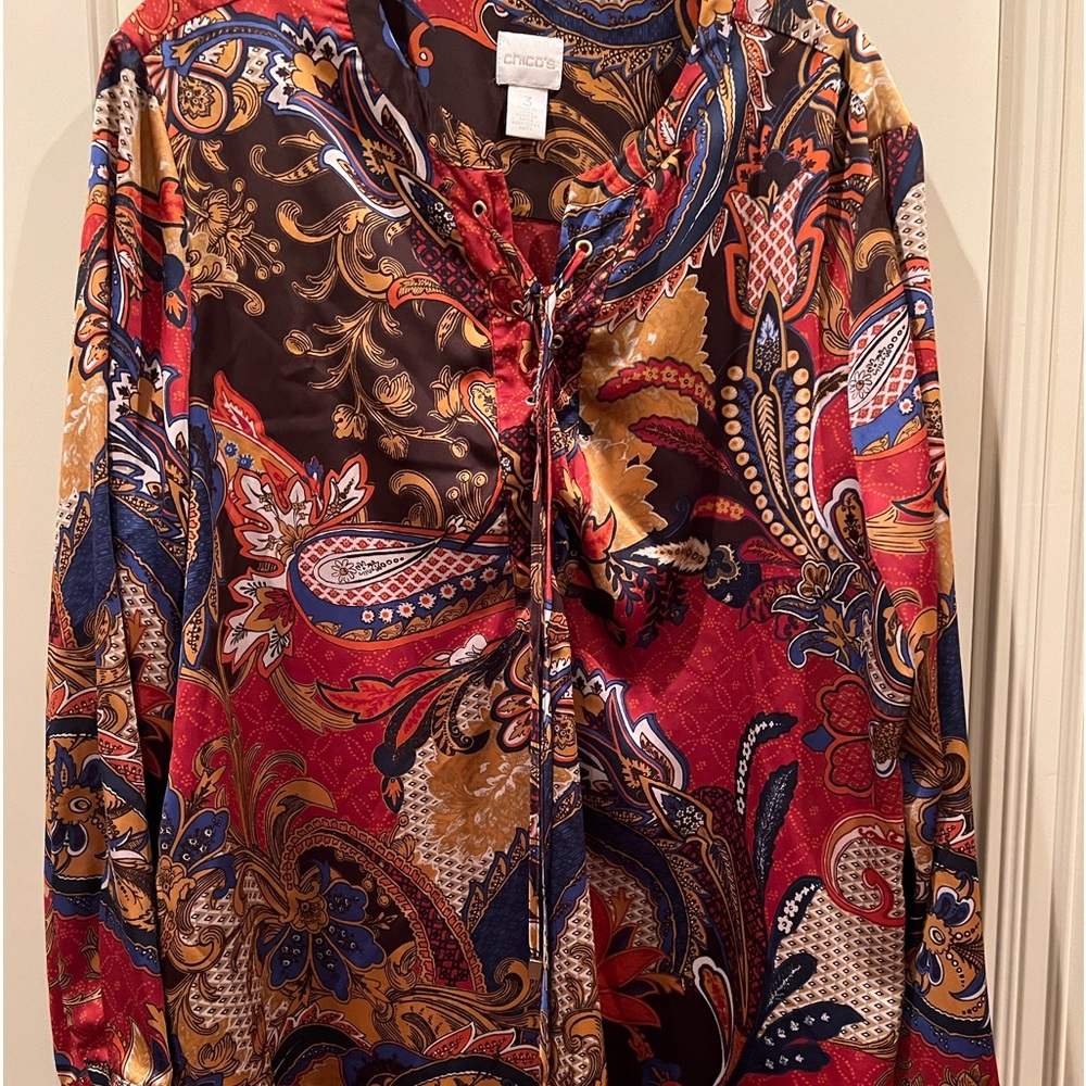 Chico’s  multicolor pull over silky blouse, size extra large ties at the neck